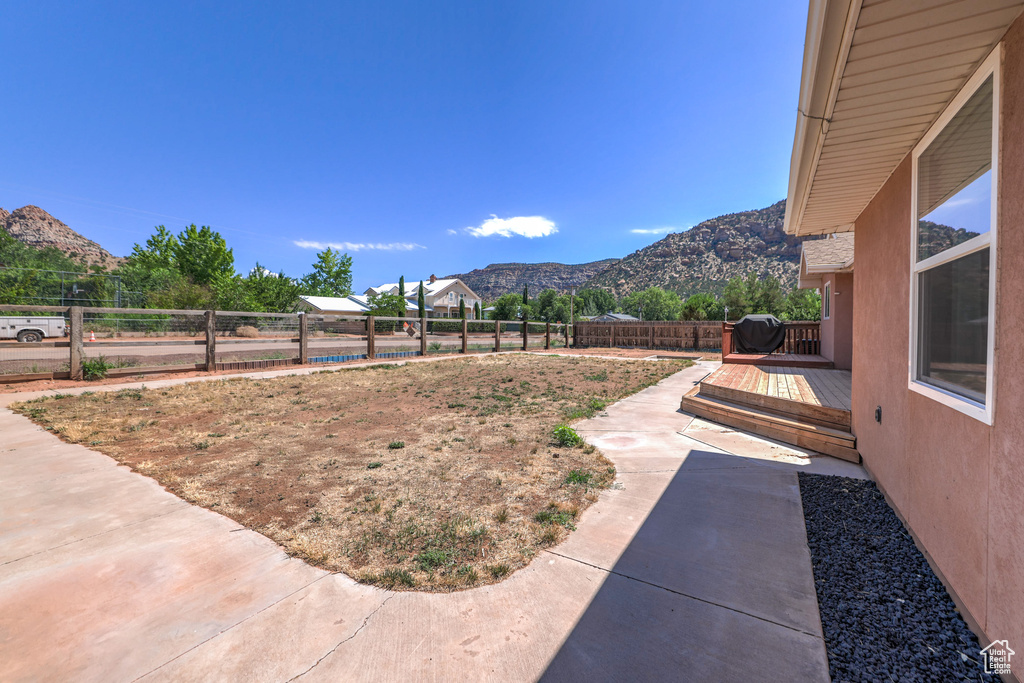View of yard featuring a deck with mountain view