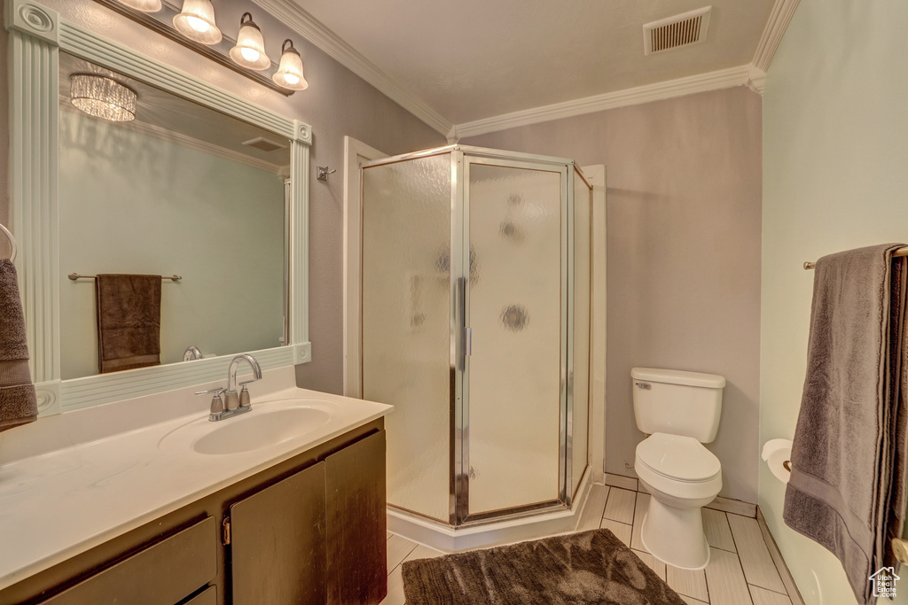Bathroom with an enclosed shower, tile floors, oversized vanity, and toilet