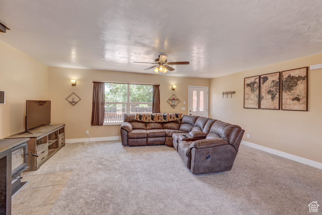 Living room with ceiling fan and light colored carpet