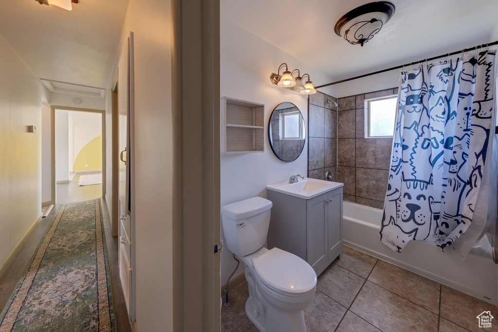Full bathroom with shower / tub combo, vanity, tile floors, and toilet