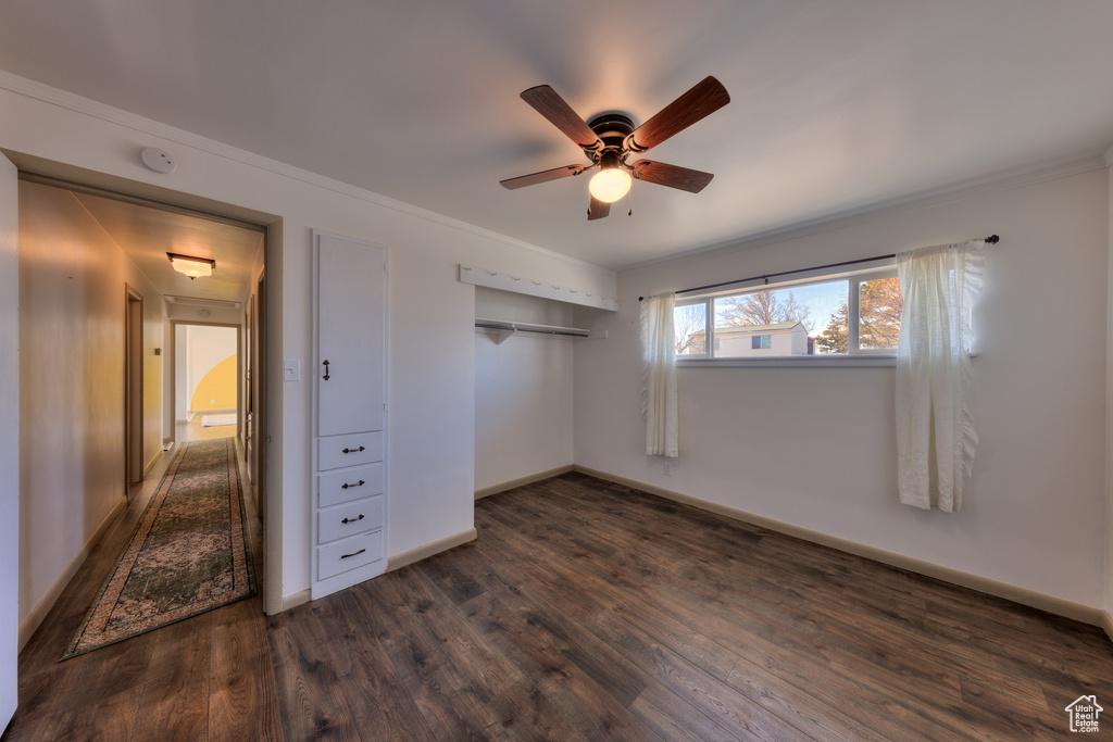 Unfurnished bedroom with a closet, ceiling fan, and dark hardwood / wood-style floors