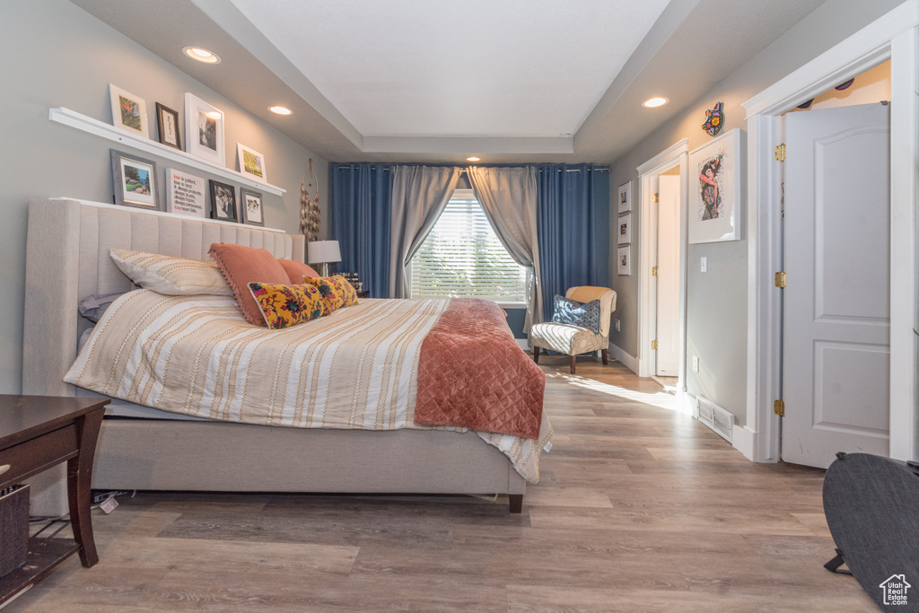 Bedroom with wood-type flooring