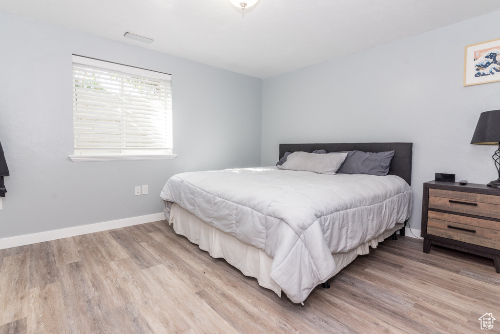 Bedroom with light hardwood / wood-style flooring