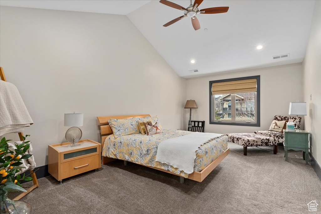Bedroom featuring lofted ceiling, dark carpet, and ceiling fan