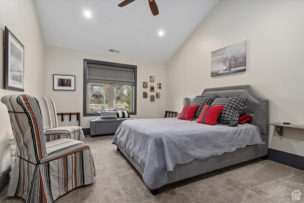 Bedroom featuring light carpet, lofted ceiling, and ceiling fan