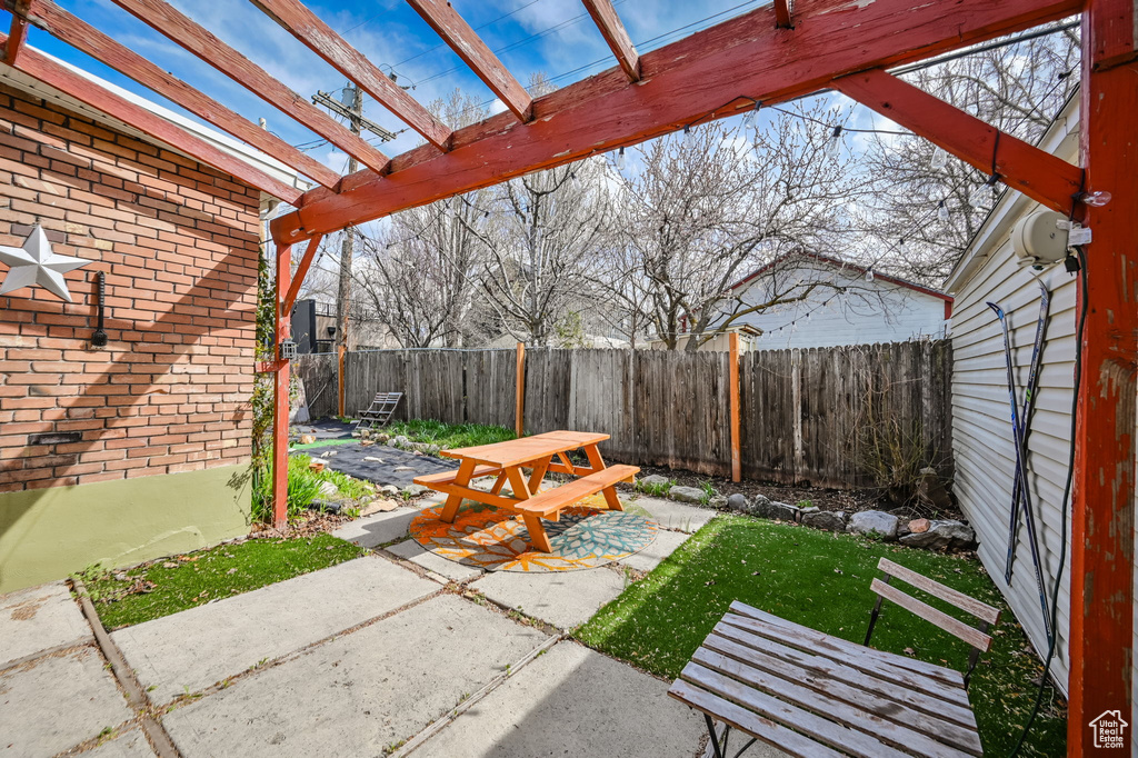 View of yard with a pergola and a patio