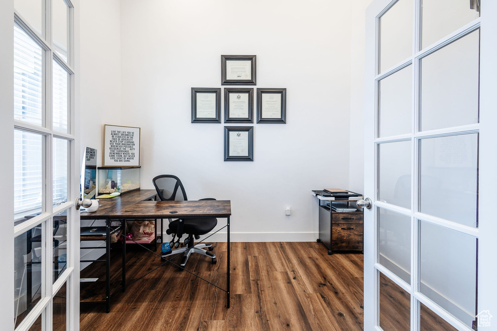 Office space featuring french doors and dark wood-type flooring
