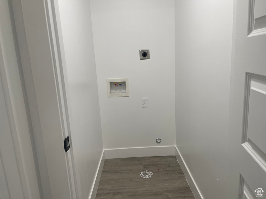 Washroom with hookup for an electric dryer, dark hardwood / wood-style flooring, and hookup for a washing machine