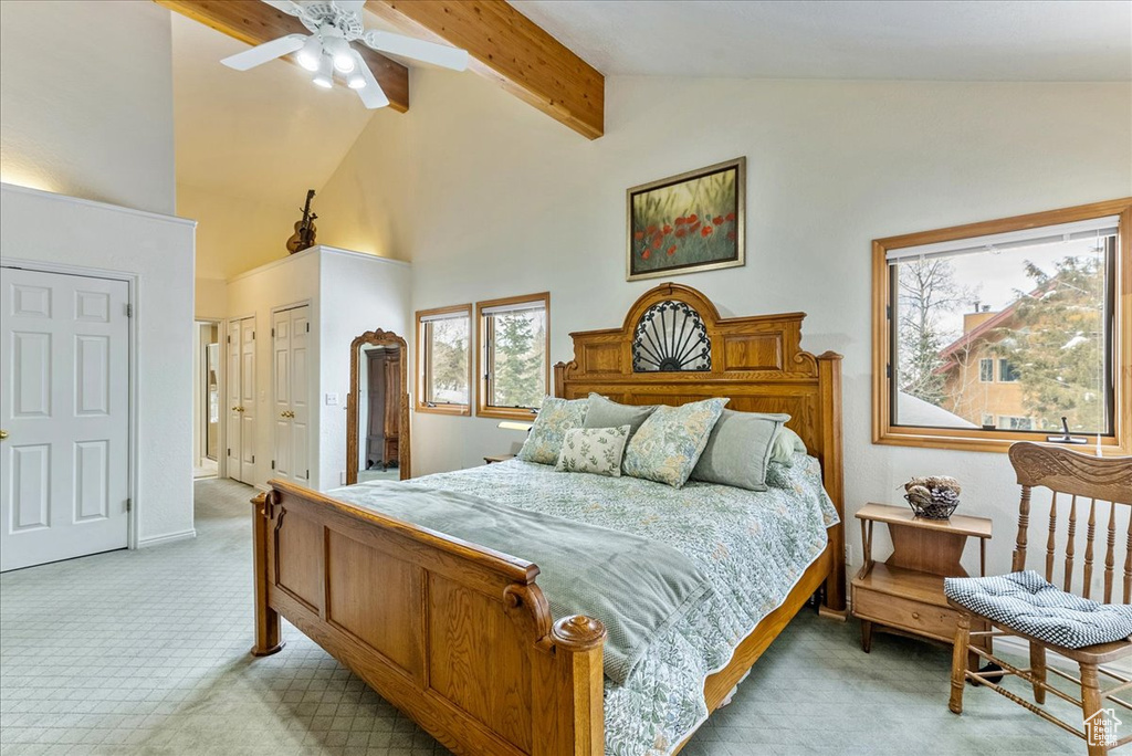 Bedroom featuring high vaulted ceiling, light colored carpet, ceiling fan, and beamed ceiling