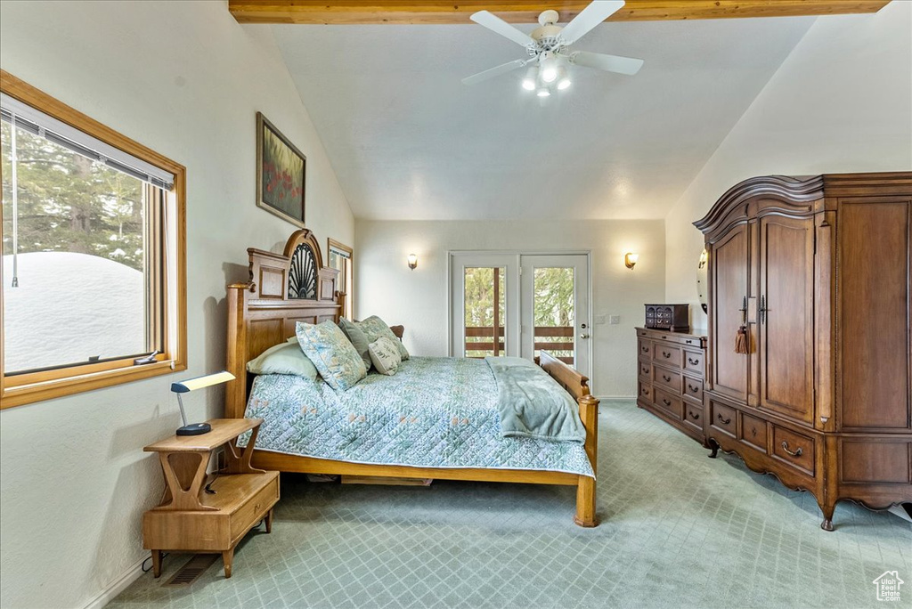 Bedroom with vaulted ceiling with beams, access to exterior, ceiling fan, french doors, and light carpet