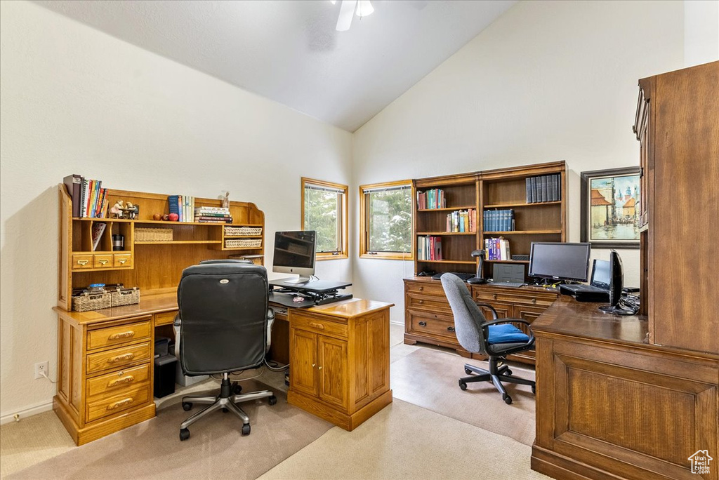 Carpeted home office with high vaulted ceiling