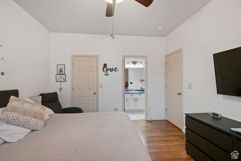 Bedroom featuring connected bathroom, ceiling fan, and light hardwood / wood-style flooring
