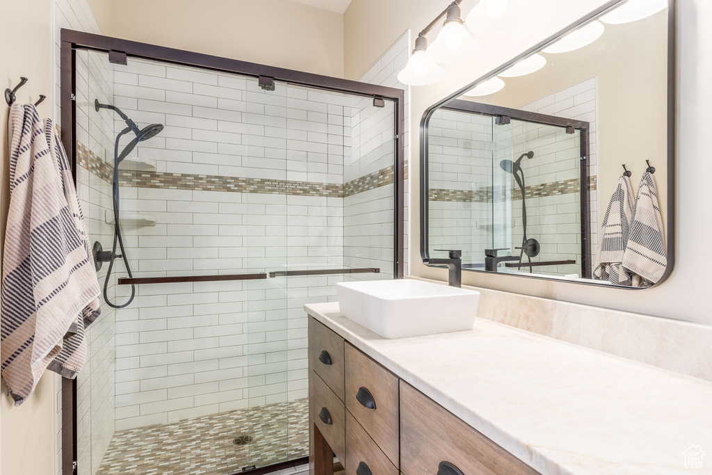 Bathroom with a shower with shower door and large vanity