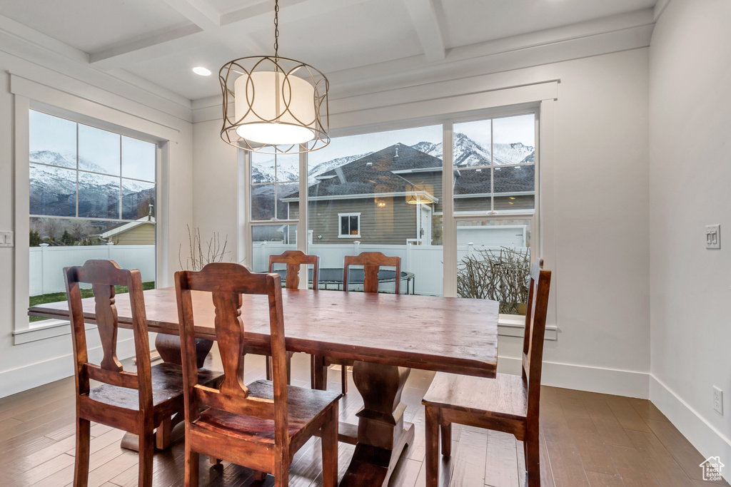 Dining area featuring coffered ceiling, a mountain view, dark hardwood / wood-style floors, and beam ceiling