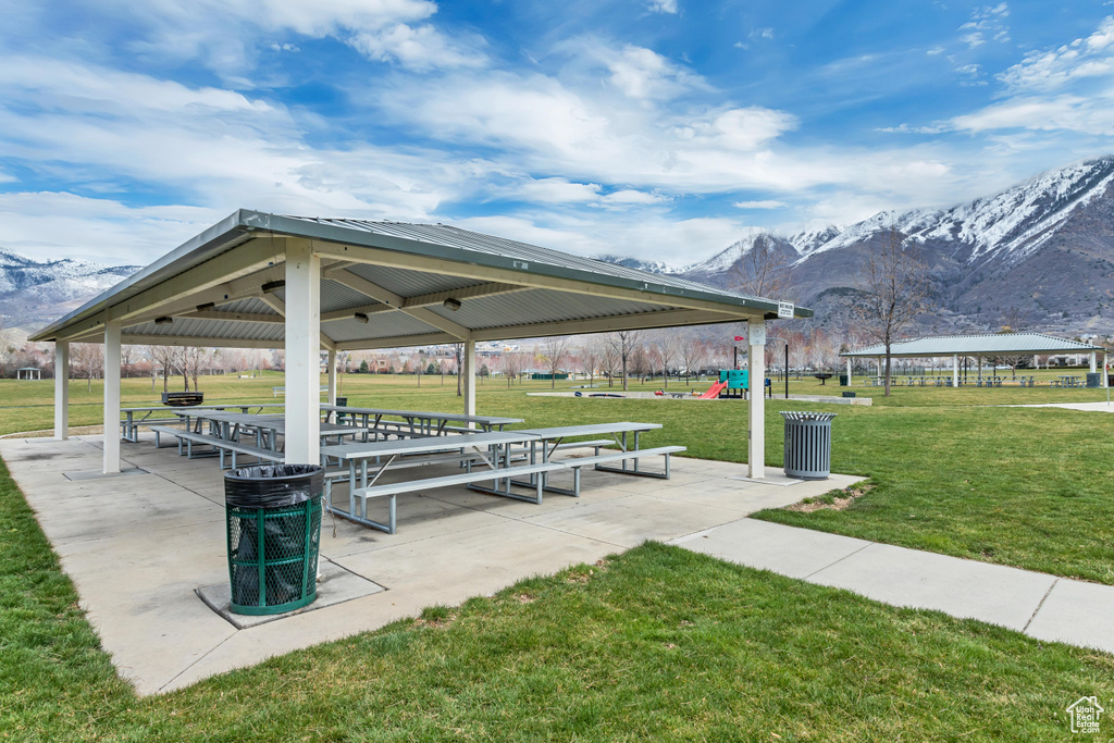 Surrounding community with a playground, a patio area, a mountain view, a lawn, and a gazebo