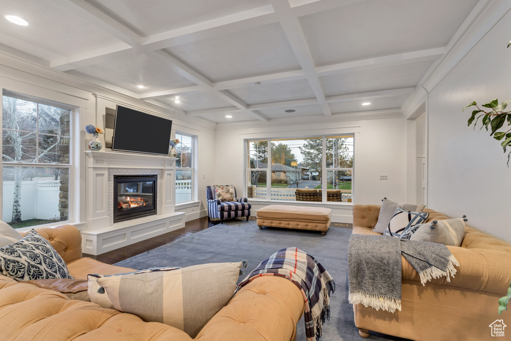 Living room with coffered ceiling, dark wood-type flooring, and beam ceiling