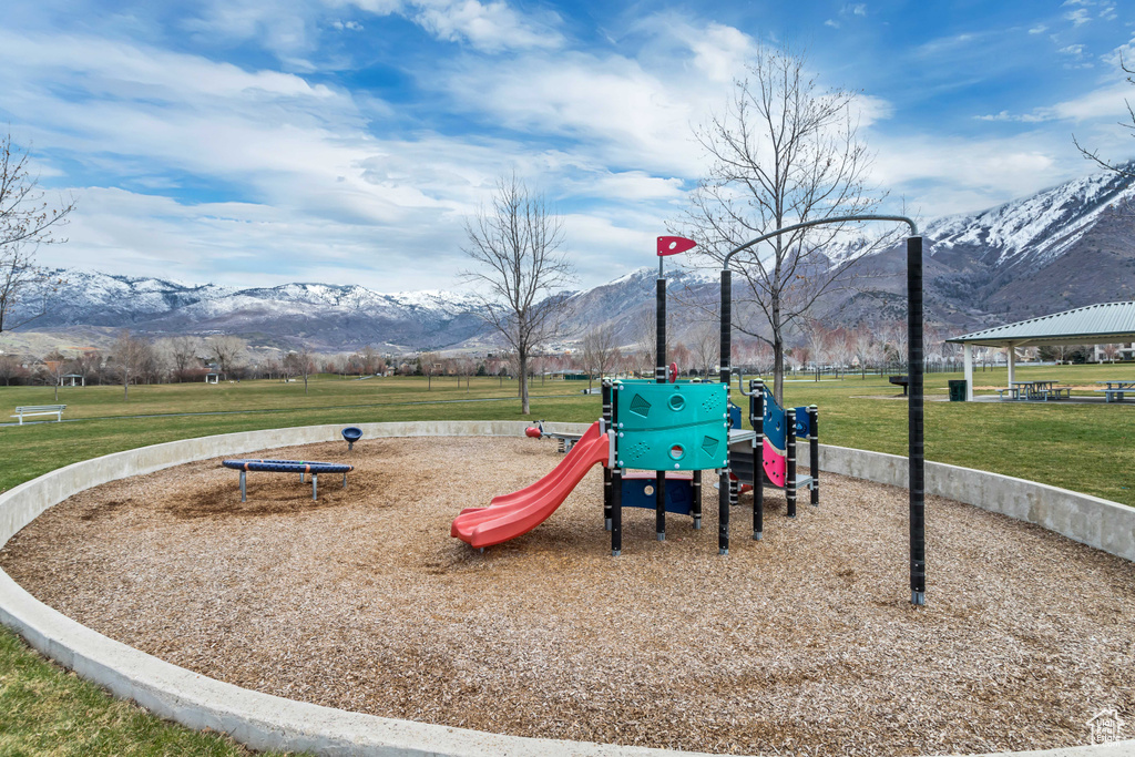 View of play area featuring a lawn, a gazebo, and a mountain view