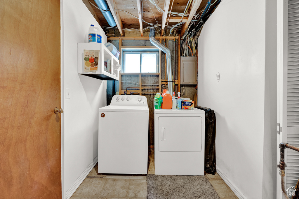 Laundry room with washer and dryer, washer hookup, and light tile floors