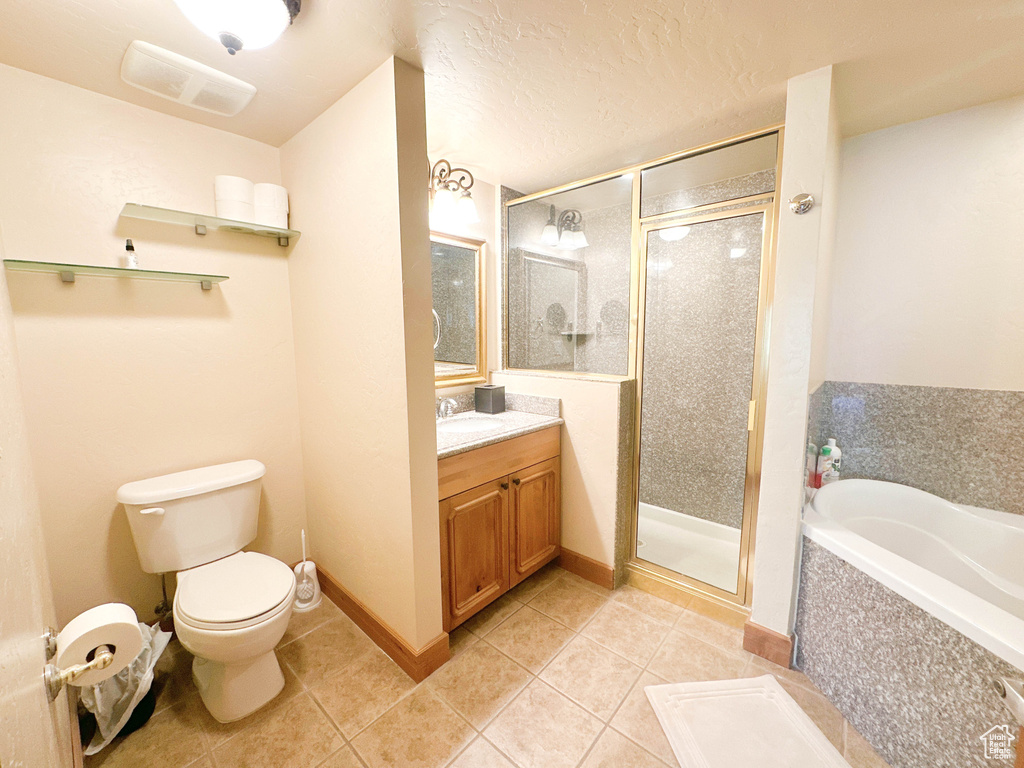 Full bathroom with shower with separate bathtub, tile floors, toilet, and oversized vanity