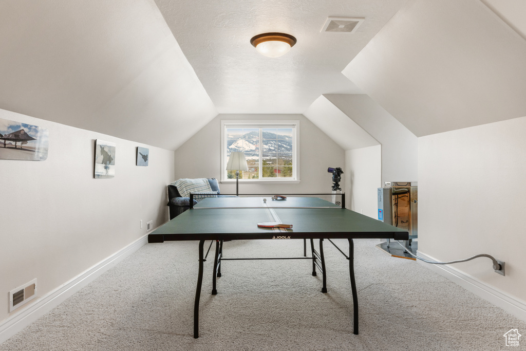 Playroom featuring light carpet and vaulted ceiling