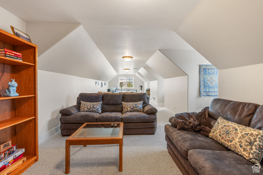 Living room featuring light carpet and lofted ceiling