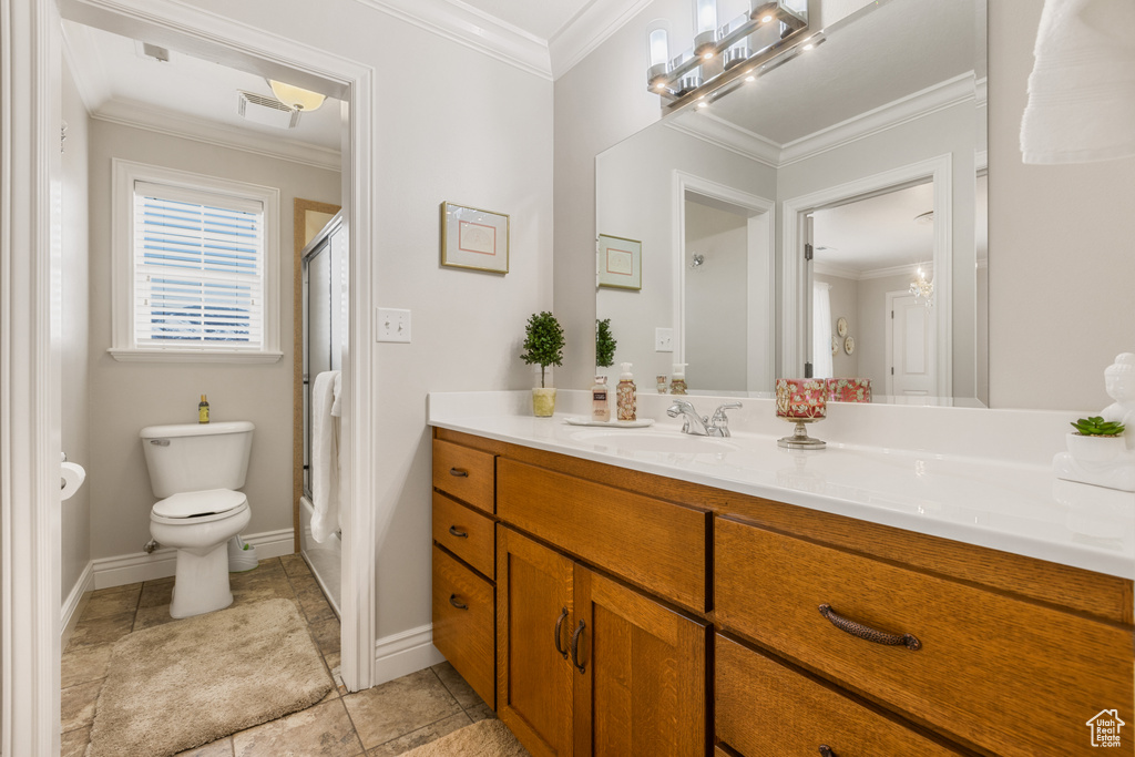 Bathroom featuring vanity, tile flooring, toilet, and ornamental molding