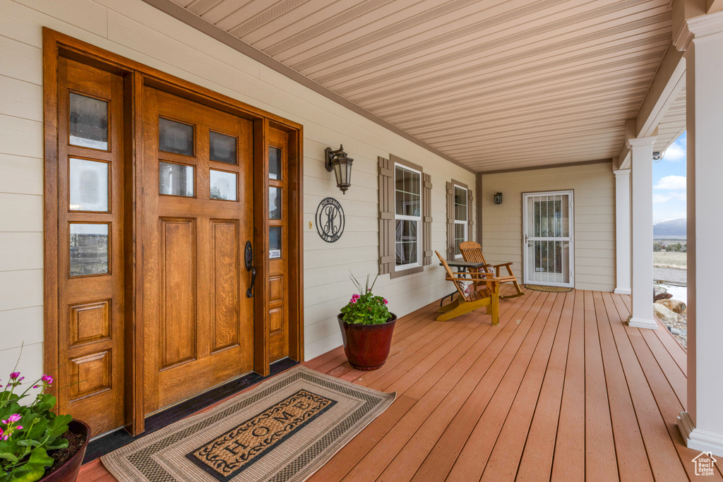Doorway to property with covered porch