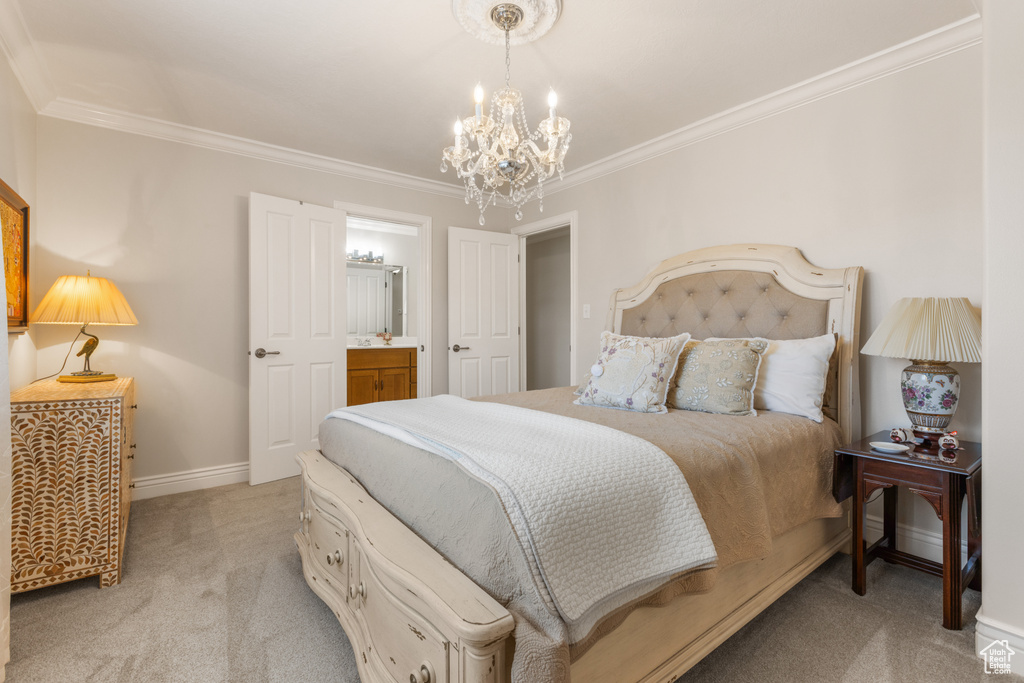 Bedroom featuring an inviting chandelier, light carpet, and crown molding