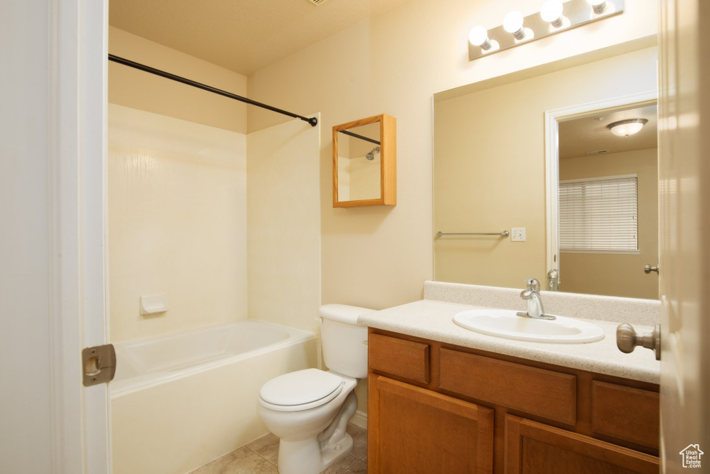 Full bathroom with shower / bathtub combination, toilet, tile floors, and oversized vanity