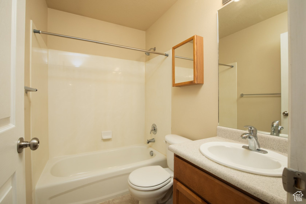 Full bathroom with vanity,  shower combination, and toilet