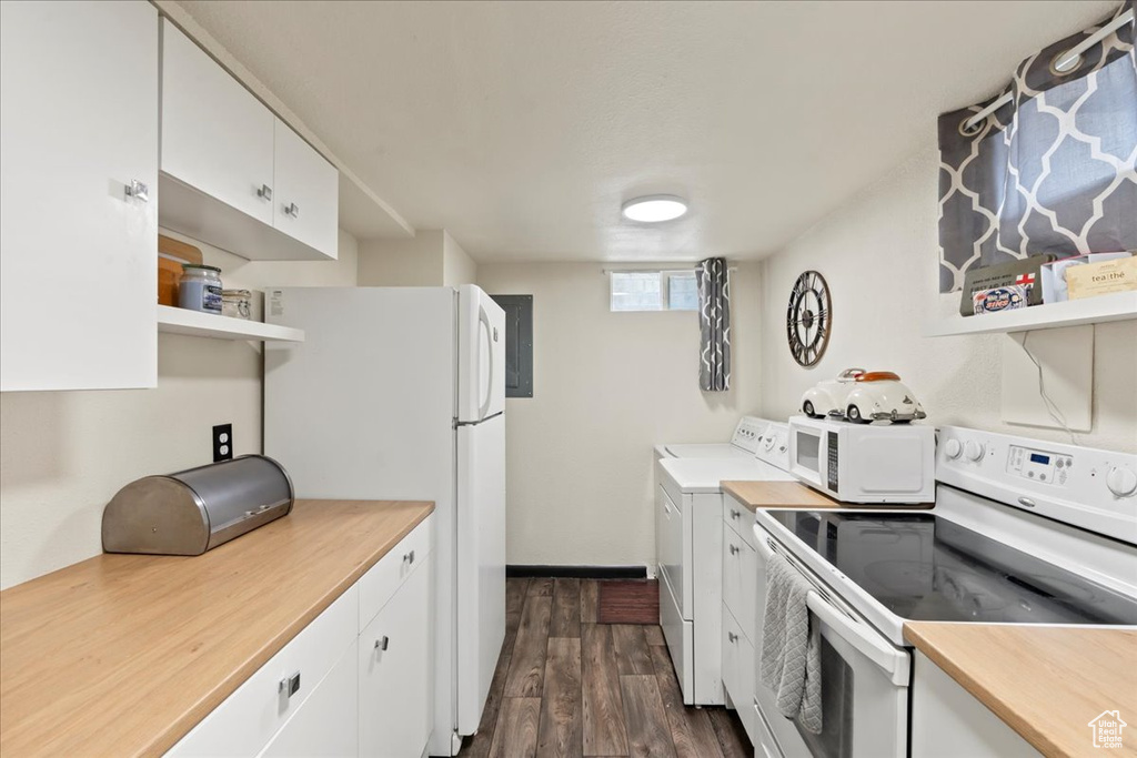 Kitchen featuring white appliances, white cabinetry, dark wood-type flooring, and washer / clothes dryer