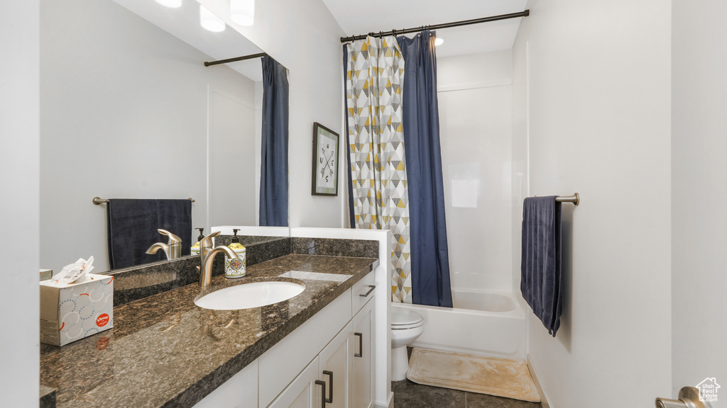 Full bathroom featuring shower / bath combination with curtain, toilet, tile flooring, and oversized vanity