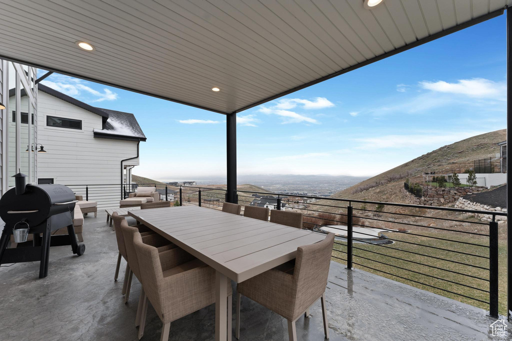 Exterior space with a balcony, a mountain view, and grilling area