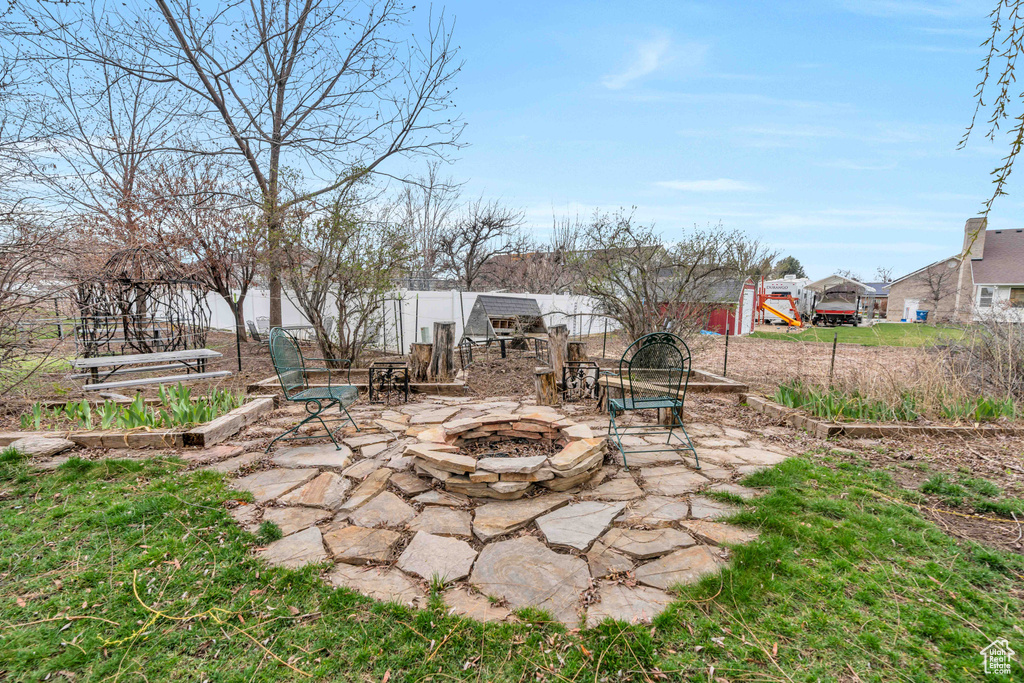 View of yard with a patio area and an outdoor fire pit