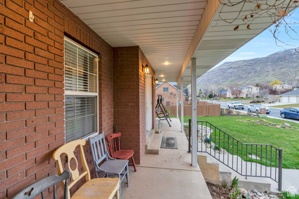 View of terrace featuring covered porch and a mountain view