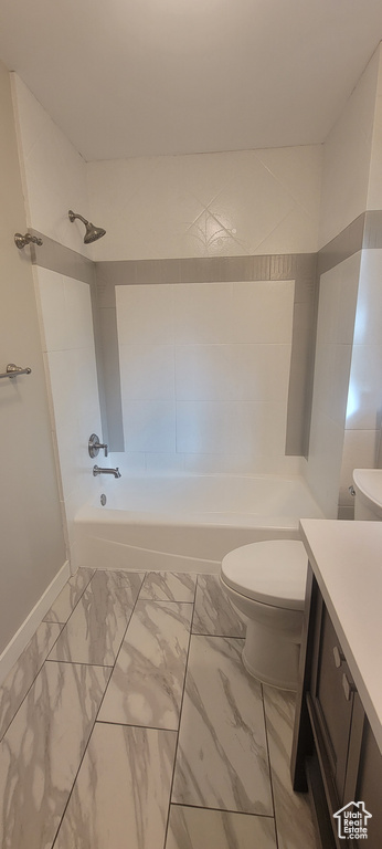 Full bathroom with shower / washtub combination, toilet, tile floors, and vanity