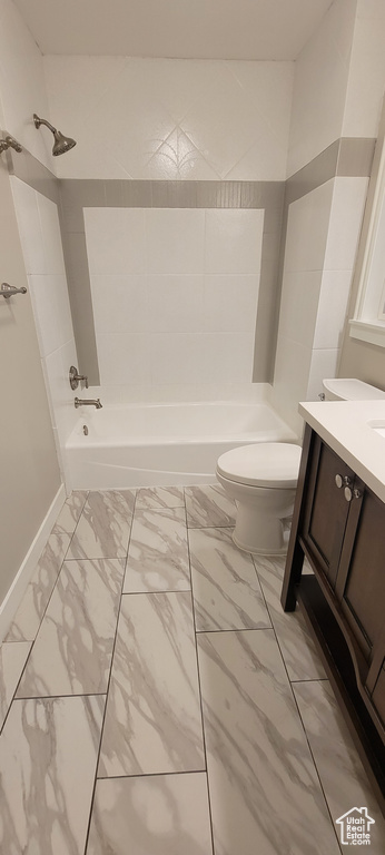 Full bathroom with toilet, vanity, tiled shower / bath, and tile flooring