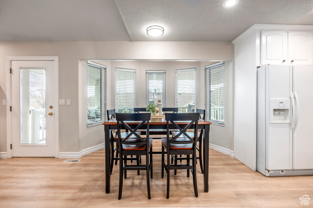 Dining room with light hardwood / wood-style flooring
