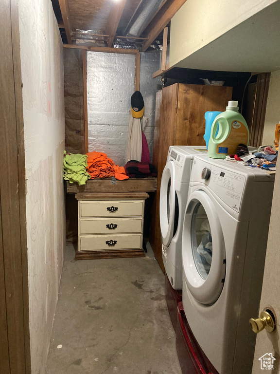 Clothes washing area featuring washer and dryer