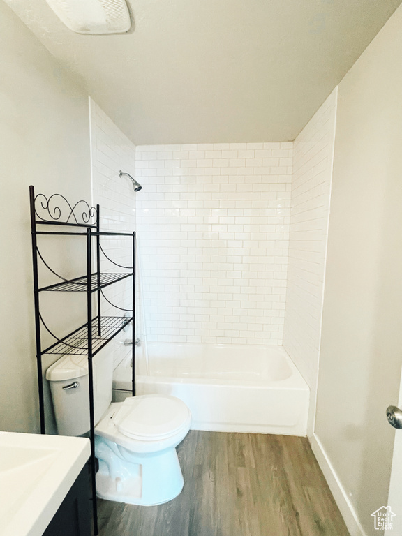 Full bathroom featuring vanity, hardwood / wood-style floors, toilet, and tiled shower / bath
