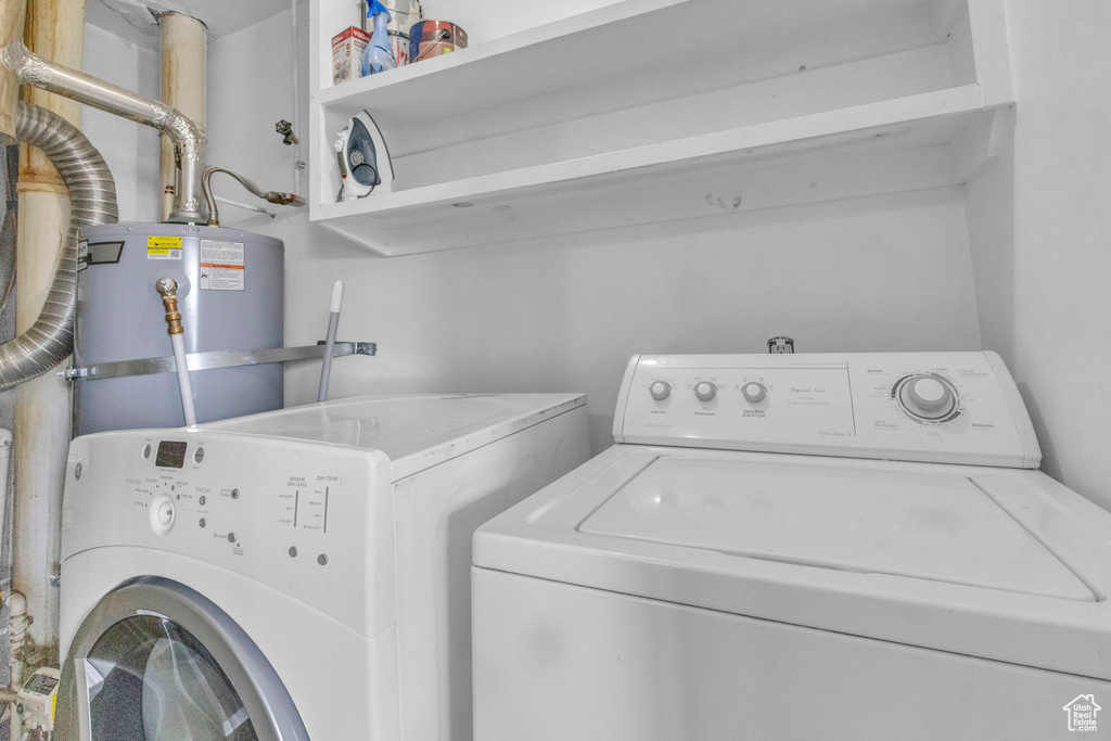 Laundry room featuring gas water heater and washer and clothes dryer