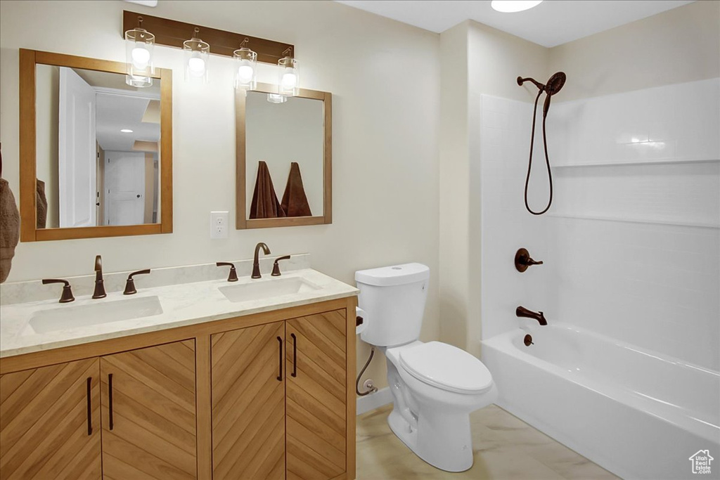 Full bathroom featuring tile floors, shower / bathing tub combination, toilet, and dual bowl vanity