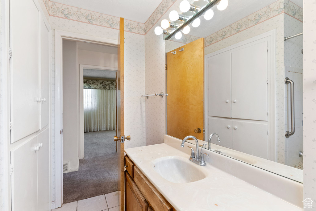 Bathroom with tile flooring and vanity