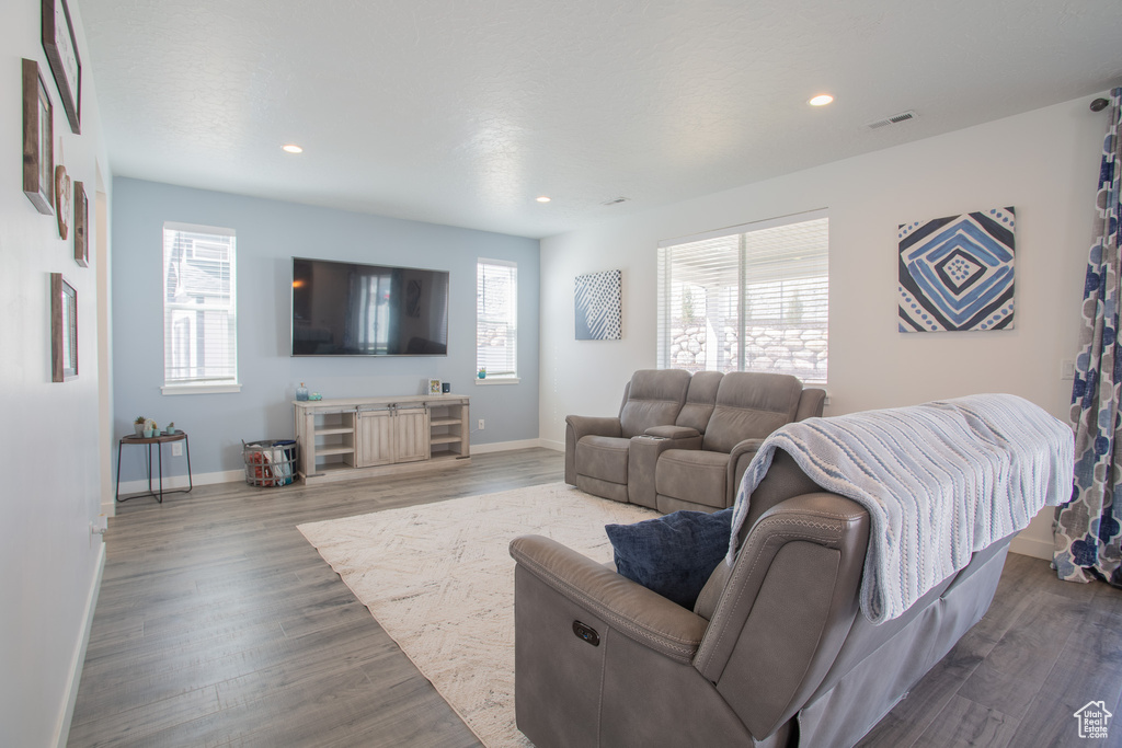 Living room with plenty of natural light and dark hardwood / wood-style flooring