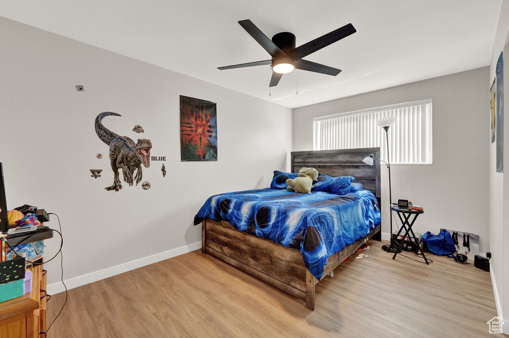 Bedroom featuring ceiling fan and light hardwood / wood-style flooring