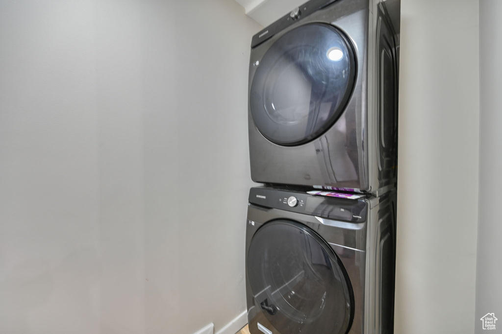 Laundry area with stacked washer and dryer