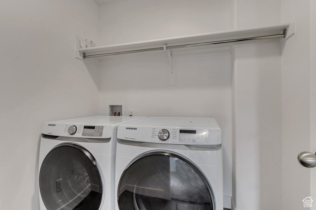 Laundry area featuring hookup for a washing machine and washing machine and dryer