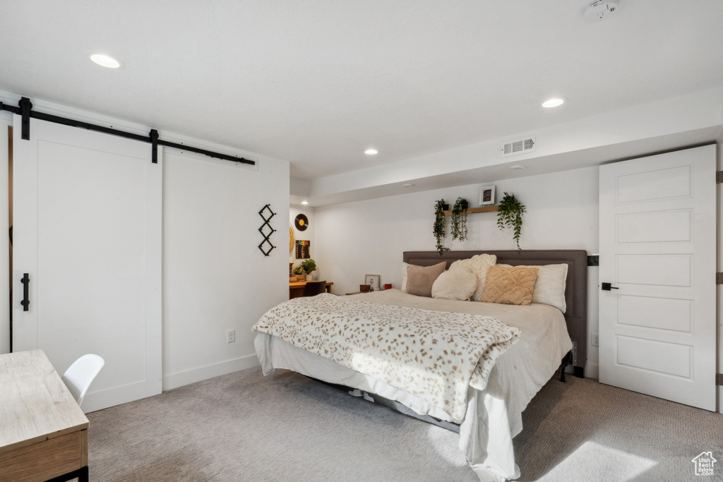 Carpeted bedroom with a barn door