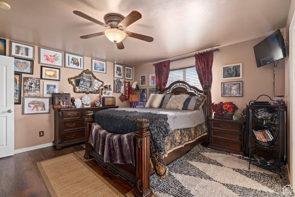 Bedroom featuring ceiling fan and dark wood-type flooring