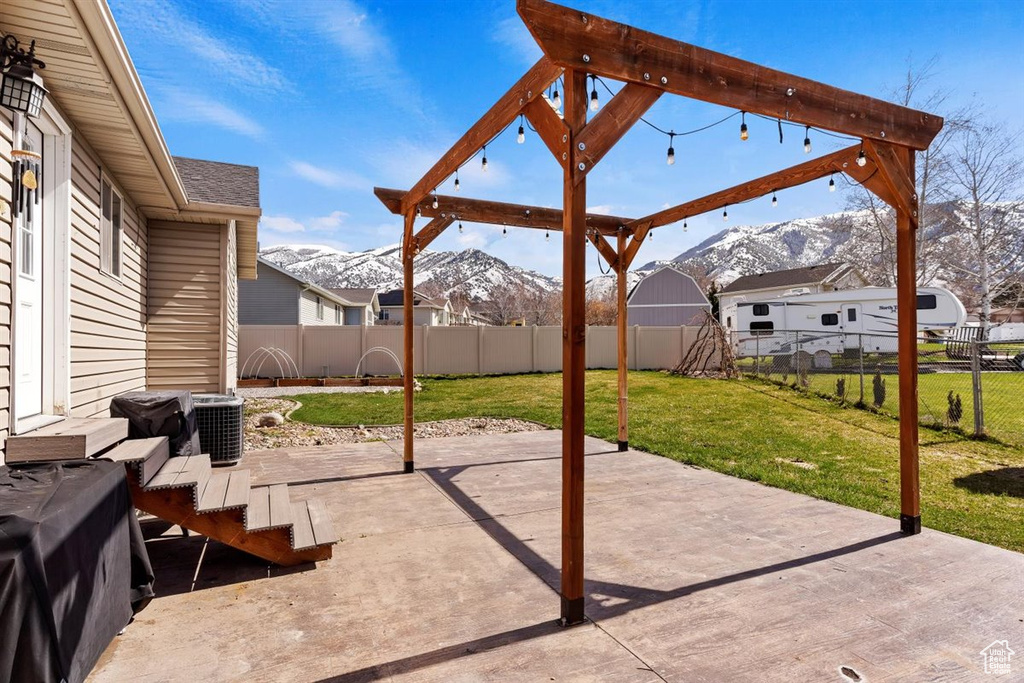 View of patio featuring a shed and a mountain view